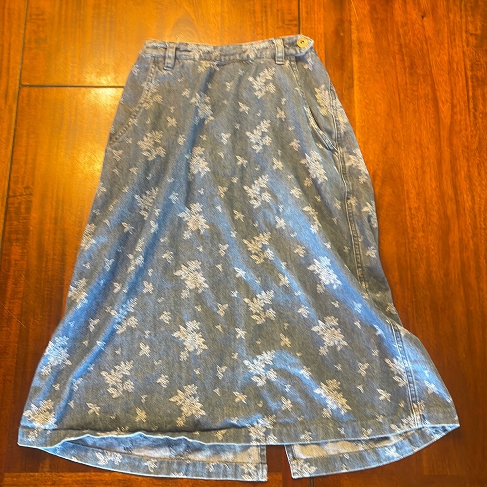 Long denim skirt with floral patterns
